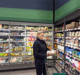 supermarket shopping,Woman choosing a dairy products at supermarket.