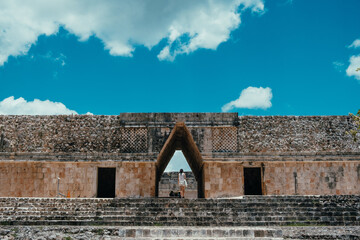 Girl standing in the middle of the door of a maya temple at Uxmal, Yucatan - Powered by Adobe