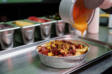preparation of a vegan salchipapa in the kitchen, food
