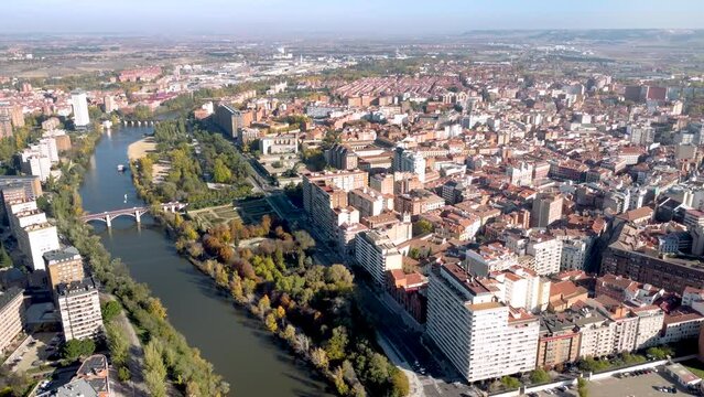 Aerial perspective of Valladolid city. Situated in Spain, in Castilla y Leon Province. View of River Pisuerga and La Rosaleda Park. Drone forward. Beautiful panorama of whole city. 