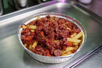 preparation of a vegan salchipapa in the kitchen, food
