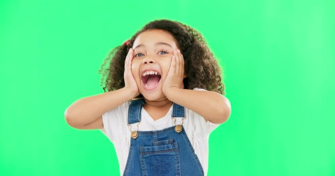 Shocked, surprise and child hands on face screaming and excited, happy and winning isolated in a studio green screen background. Portrait, young and kid with surprised facial expression due to news