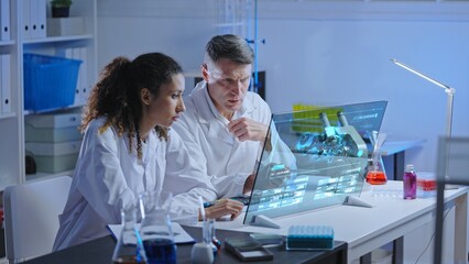 Two scientists looking at experiment results on holographic computer screen, research