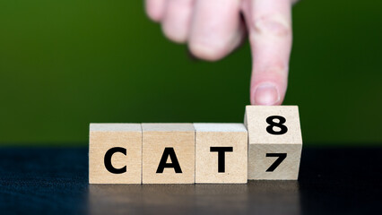 Symbol for network technology. Hand turns cube and changes the expression CAT7 to CAT8.