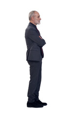 side view of a man standing with suit and  arms crossed  on white background