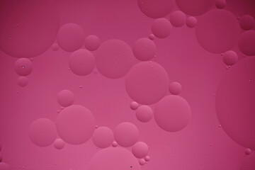 Pink abstract background with oil circles, streaks and gradient.