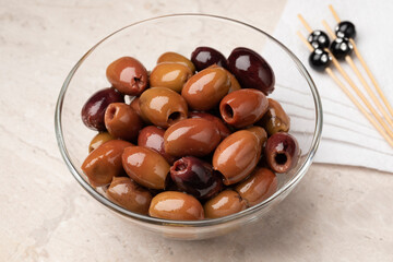 Glass bowl with pitted Italian Leccino olives close up