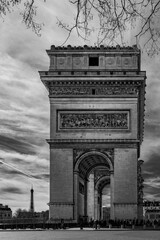 Fototapeta na wymiar Arc de Triomphe at Sunrise with the view of Eiffel Tower in Paris, France, monochromatic photography