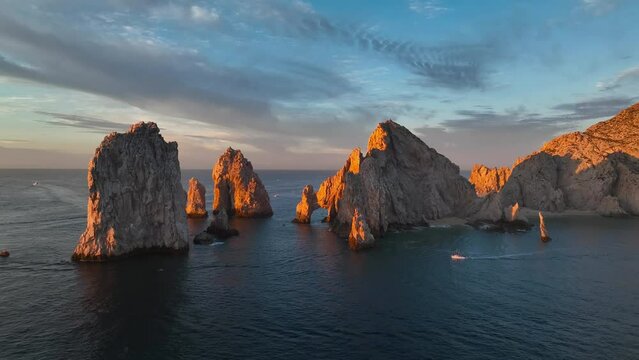 Orange light early sunrise on the Cabo Arch at land's end. Cabo San Lucas Arch, Los Cabos Mexico.