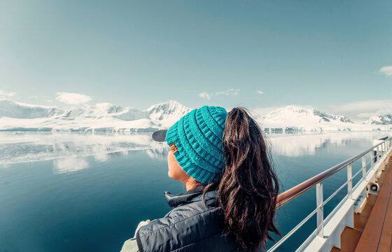 Female Tourist On Luxury Antarctica Cruise Ship Looking Out At The Stunning Peaceful Scenic Arctic Landscape, landscape Shot