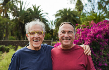 Senior men smiling on camera after sport training at city park - Eldlery people and healthy lifestyle concept
