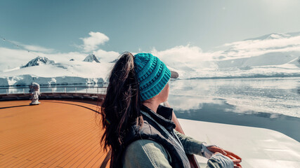 Female Tourist On Luxury Antarctica Cruise Ship Looking Out At The Stunning Scenic Arctic Landscape, Bow of Ship © ANITEK MEDIA 