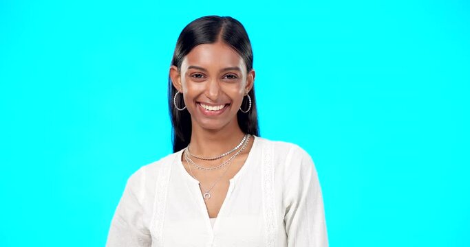 Laughing, studio and Indian woman face with blue background hearing comedy. Emoji, comic and happy portrait of a young female smiling about a funny joke isolated with happiness, joy and confidence