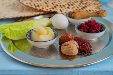 Symbolic meal for Passover (Pesach) Seder Plate. Walnuts and date fruits on the background of traditional food for Pesach.