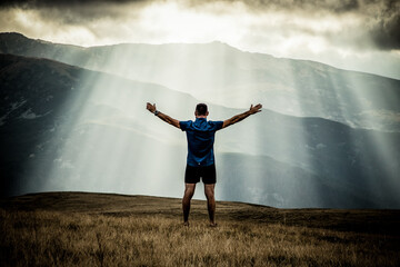 Fototapeta na wymiar man silhouette against heavenly lights in mountains freedom concept
