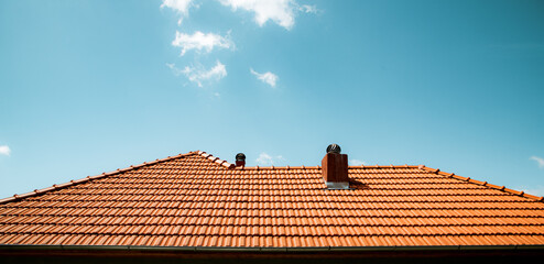 new red tiles roof and blue sky - obrazy, fototapety, plakaty