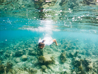 woman snorkeling in clear tropical sea