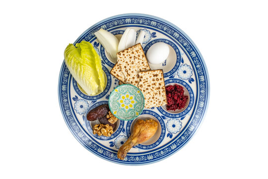 Symbolic meal (matzah, vegetables, nut date mix, bitter herbs, egg) for Passover (Pesach) Seder Plate. Traditional Seder Plate on white background.