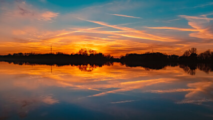 Obraz premium Sunset with reflections near Plattling, Isar, Bavaria, Germany