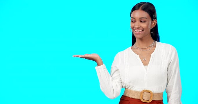 Woman, studio mockup and open palm with face, fashion and beauty in space by blue background. Happy indian model, gen z girl and hand for product placement, branding or logo in mock up promo portrait