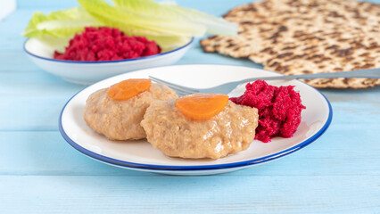 Gefilte fish for Jewish holiday Pesach (Passover) on ceramic plate.
