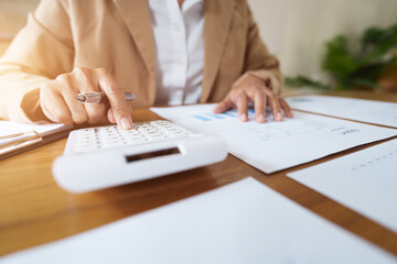 Business administrator calculates profit in a conference room..