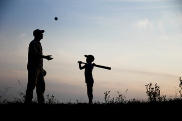silhouette Happy child with parent playing baseball concept