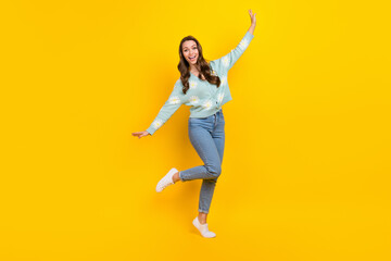 Fototapeta na wymiar Full length photo of young carefree lady have fun enjoy her new apparel shopping sale advert dancing relax isolated on yellow color background