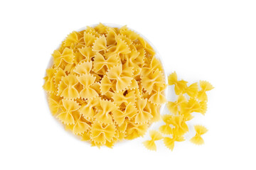 Farfalle in bowl isolated on white background. Raw pasta butterfly shape, ingredient for cook, traditonal italian cuisine. Top view, flat lay