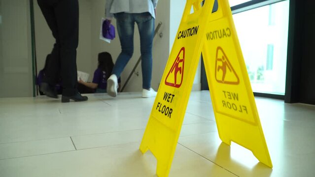 Wet floor yellow warning sign. Warning sign, wet floor and students walking on wet floor