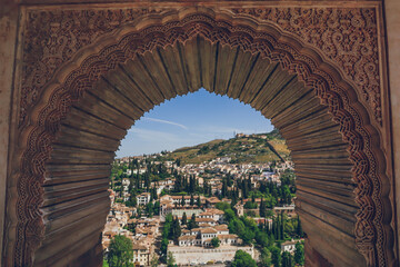 View to Granada from a moorish window with islamic details in Generalife, Alhambra, Granada, Andalusia, Andalucia, Spain