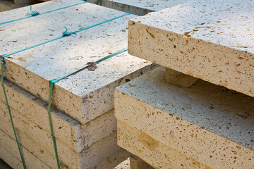 Wooden pallet of new travertine stone slabs ready to be mounted in a new pavement in a urban...