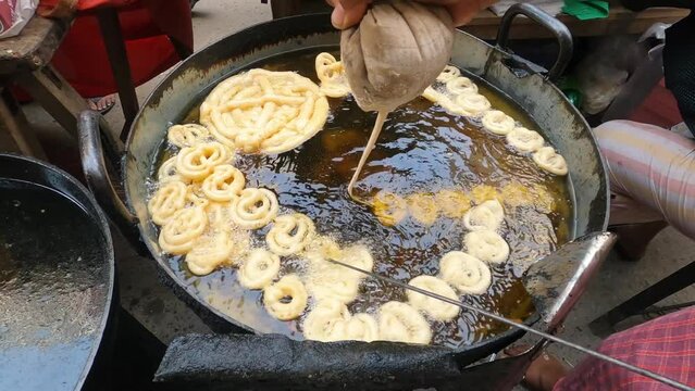 Deep oil jilabi or jilapi  making local street maket. Traditional asian food.