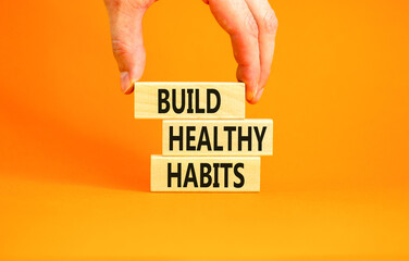 Motivation and Build healthy habits symbol. Concept words Build healthy habits on wooden block on a beautiful orange table orange background. Business build healthy habits concept. Copy space.