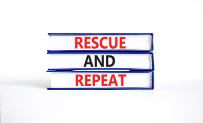 Rescue and repeat symbol. Concept words Rescue and repeat on books on a beautiful white table white...