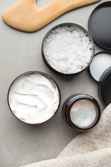 background with cosmetic products for body care. Gray bathroom. Means for massage.