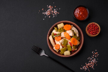 Delicious chicken slices and steamed vegetables carrots, broccoli, asparagus beans