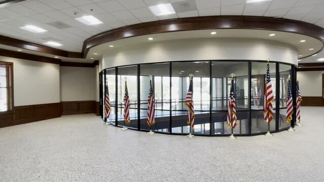 Burke County Judicial center wide pan of American Flags lines around a window traffic outside