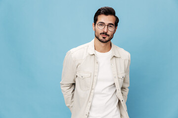 Portrait of a stylish man smile glasses for farsightedness and myopia, on a blue background in a white T-shirt, space space
