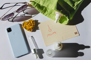A women's cosmetic bag and its contents - a card with Mother's Day