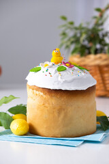 Traditional Ukrainian Easter cake with white icing and spring decoration on white background with copy space. Happy Easter. Recipe of Easter bakery. Festive pastry for spring holidays.
