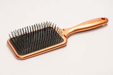 A red hairbrush isolated on a white background. Hair tools.