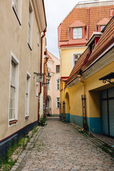 Fototapeta na wymiar Quiet picturesque European side street in historic medieval capital Tallinn, Estonia