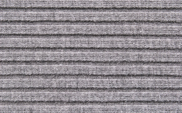Soft gray color ribbed knit fabric pattern close up as background
