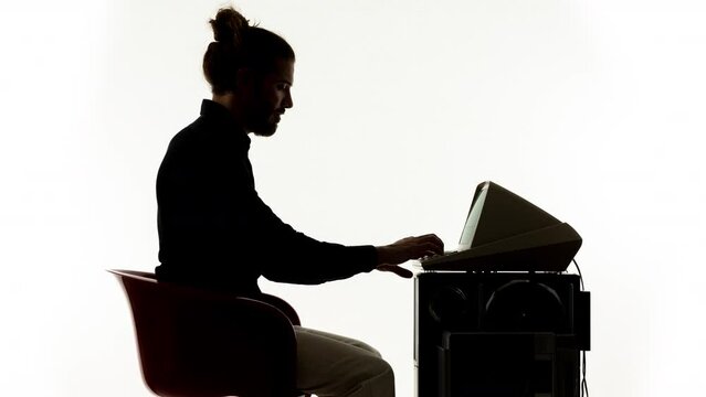 Young man working on a vintage compute