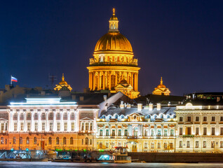 English embankment and dome of St. Isaac's Cathedral at night, Saint Petersburg, Russia