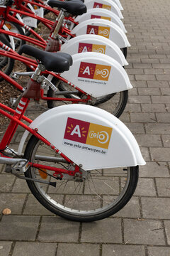 ANTWERP, BELGIUM, 11 MARCH 2023: A row of share bikes at a bike station in Antwerp. Velo is the first and biggest bike share company in Antwerp and surrounding districts. Copy space on right.