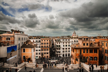 Fototapeta na wymiar Panorama of Rome photographed from the upper part of the Spanish Steps. In the centre, the famous shopping street: Via Condotti