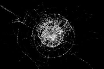 Glass broken by an impact, with black background.