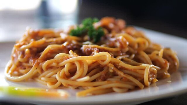Pasta with tomato sause on the plate. Close up.